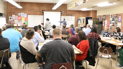 Teachers listening to speaker at presentation