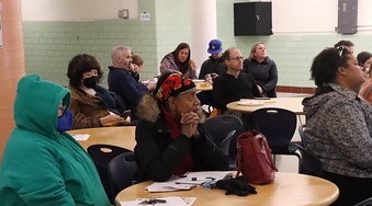 community members listening to speaker