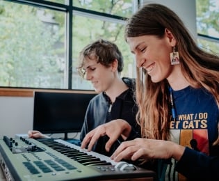 Students playing an electronic keyboard