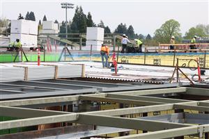 Workers installing roofing at Benson