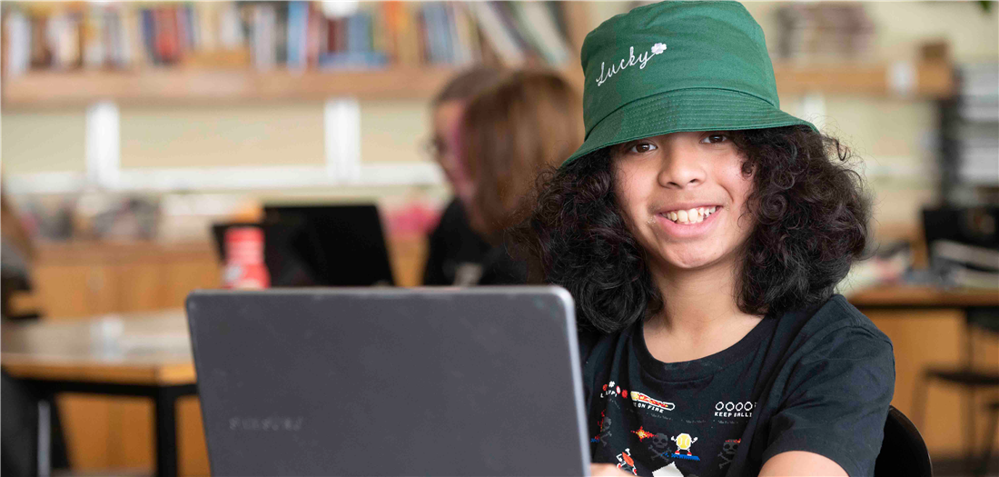 Student posing with laptop