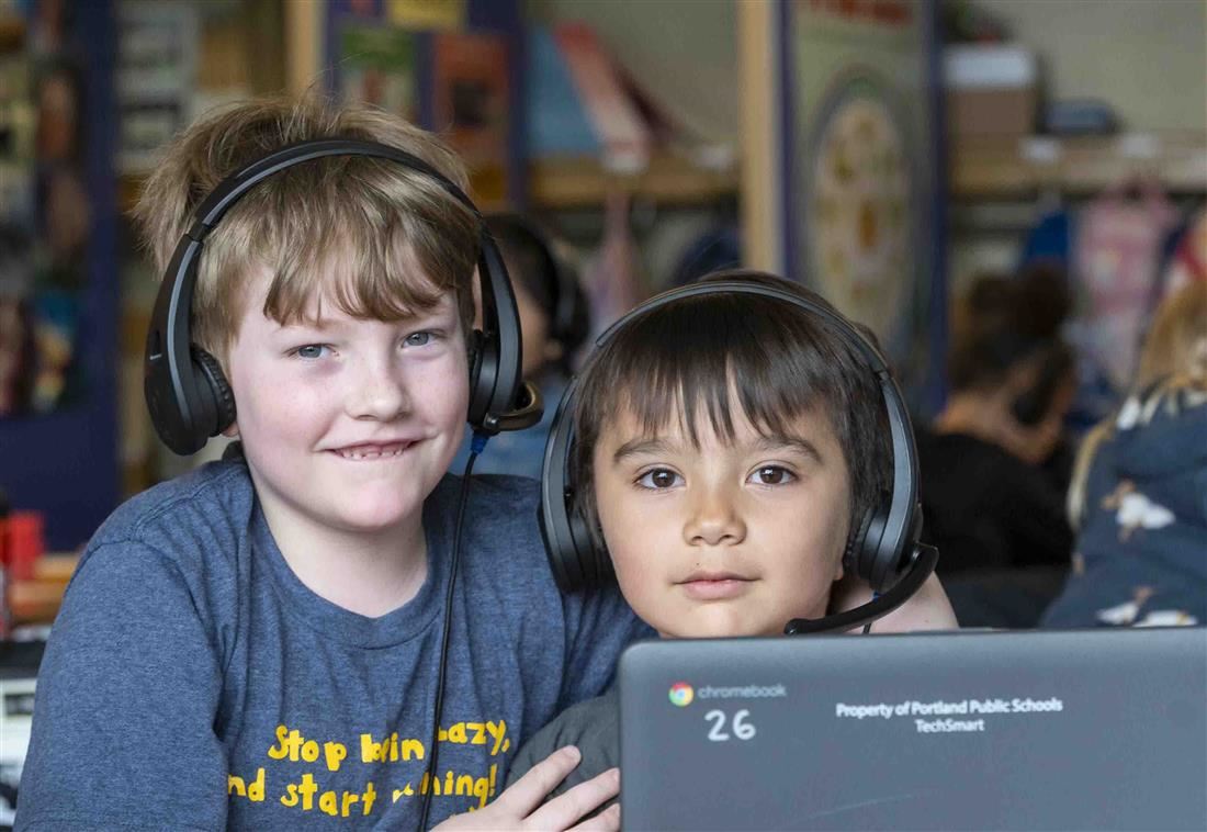 Students wearing headphones posing for photo