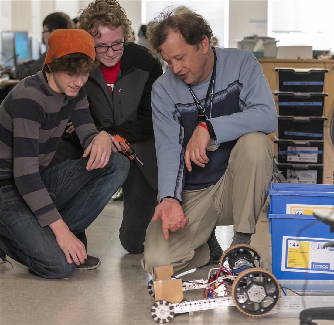 Students with instructor and remote control machine