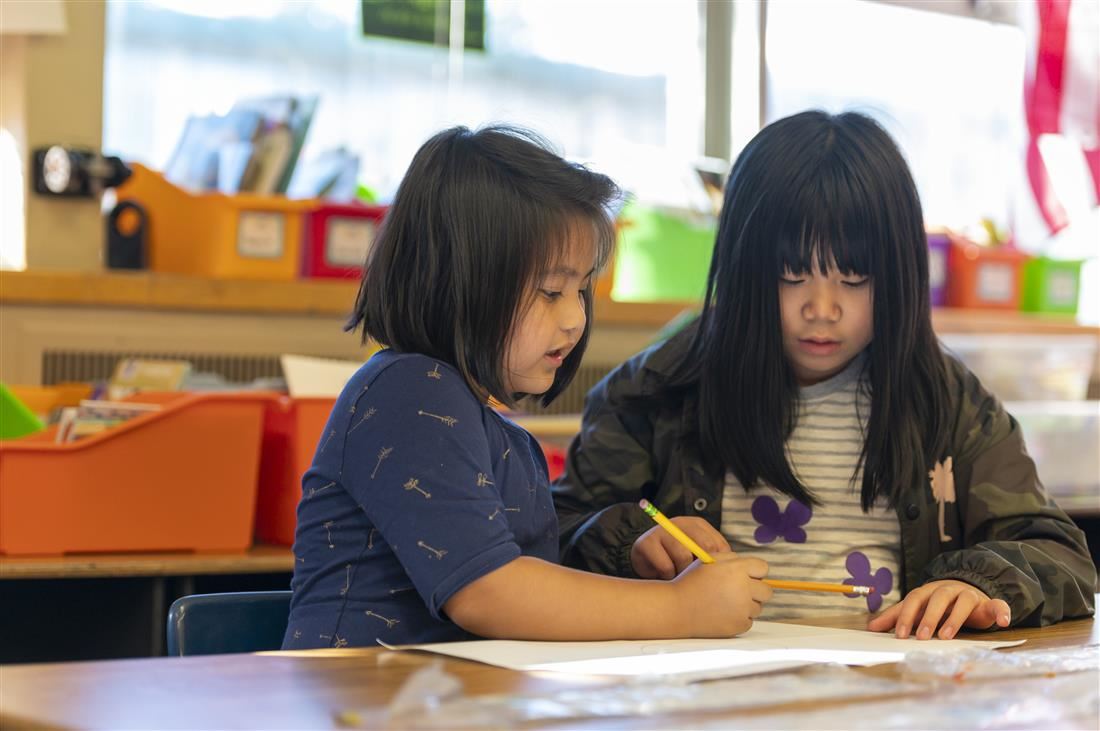 Students in classroom writing together